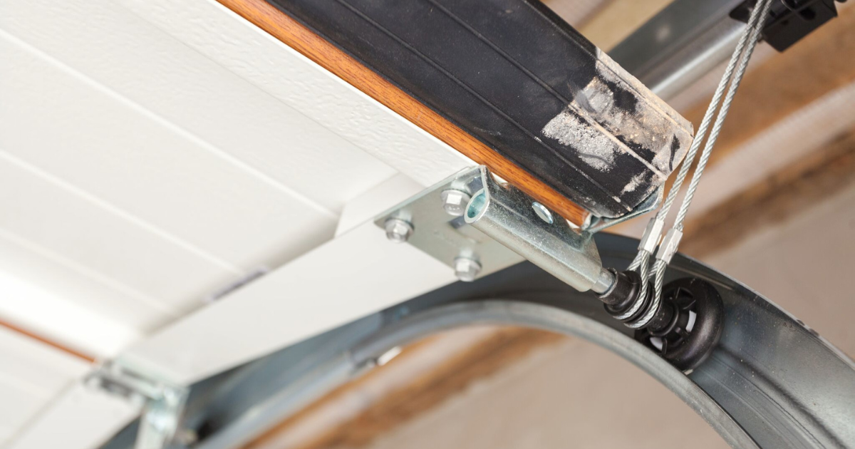 Close-up of a garage door cable and roller system.