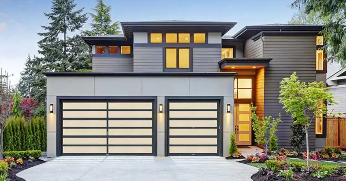Modern home with sleek garage doors at dusk.
